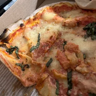 Paper thin pizza that looks like it was sitting there for a while