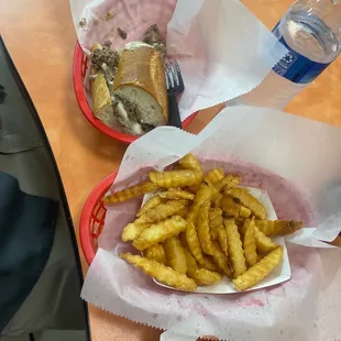 Philly cheesesteak, sandwich and fries