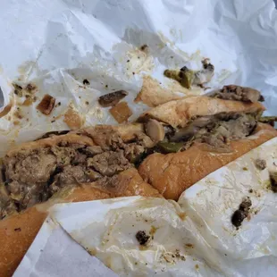 Philly cheese steak sandwich with bell peppers and mushrooms.