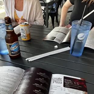 two women sitting at a table with open books