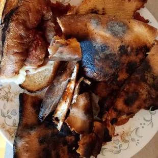 Pizza and meatball sub on same plate.