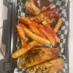 Crispy &quot;chicken&quot; with bbq sauce dunk, crinkle cut fries, half the of steak &amp; chicken Philly cheese steak egg rolls.