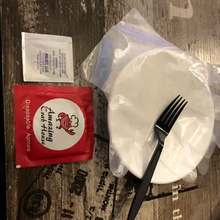 a fork, napkin, and napkin on a table