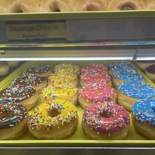 a variety of doughnuts in a display case