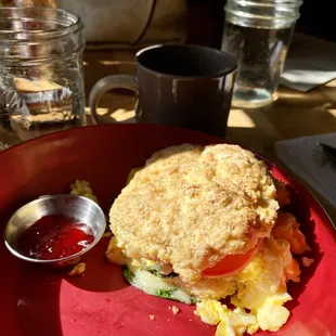 The Opus. Scrambled eggs, cheese, spinach and tomato on giant fluffy home made biscuit.