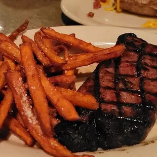 Ribeye Steak with baked potato and sweet potato fries.