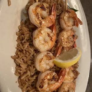 Grilled shrimp served on a bed of rice.