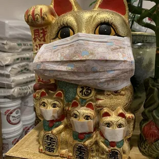 a statue of a cat with a mask on