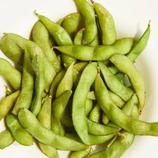 a white plate of green beans