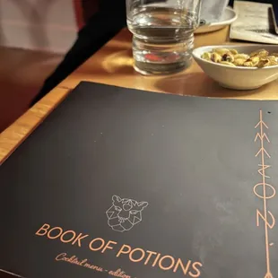 a book of potions on a table