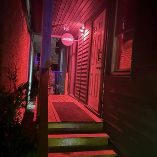 a person walking down the steps of a building at night