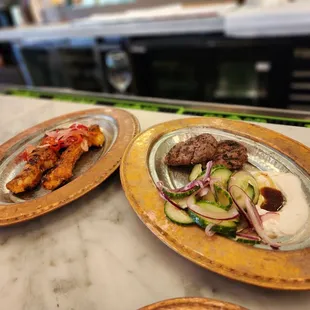 Lamb medallion on the right.  Chicken skewers on the left