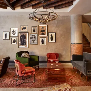 a living room with a chandelier and chairs