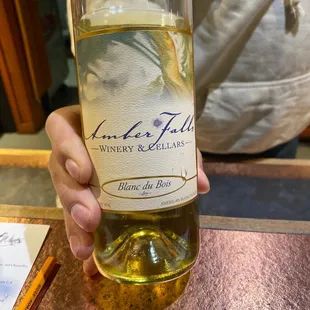 a person holding a bottle of wine