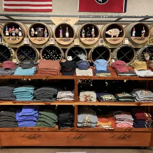 a display of shirts and wine barrels