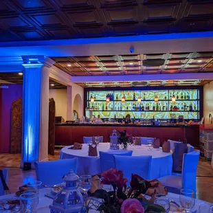 a banquet room with a bar in the background
