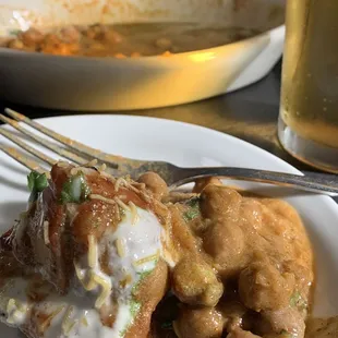 a plate of food and a glass of beer