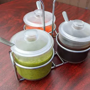 three condiments on a table