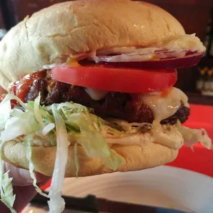 a hand holding a hamburger