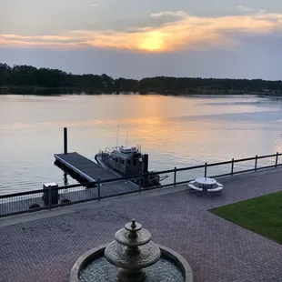 a fountain with a boat in the background
