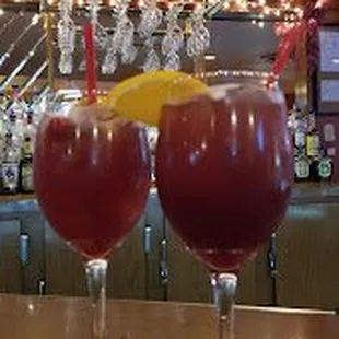 wo glasses of wine on a bar