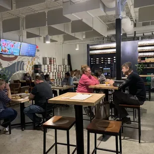 people sitting at tables in a restaurant