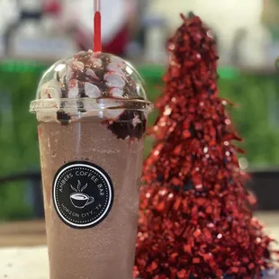 a cup of iced coffee and a christmas tree