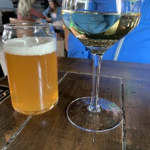 A glass of just peachy refreshing bubbly and a beer