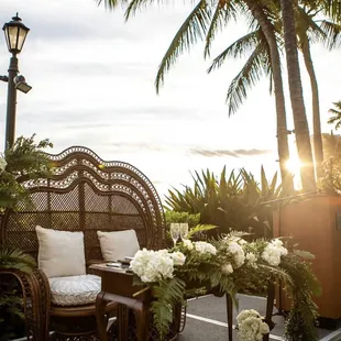 Sweetheart Table Setup. Dark Rattan Double Peacock Chair. Vintage Console Table.