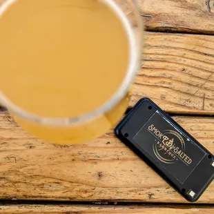 a glass of beer and a cell phone