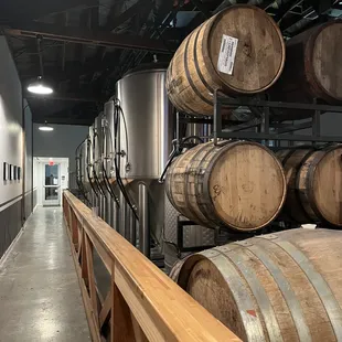 a row of barrels in a brewery