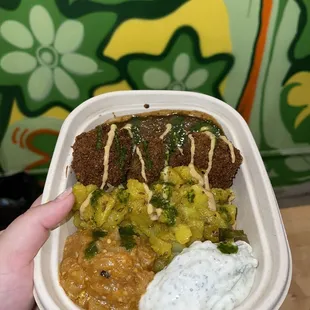 a person holding a container of food