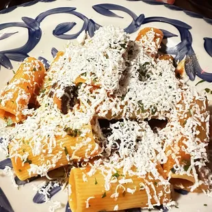 a plate of pasta with mushrooms and parmesan cheese