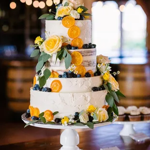 a three tiered wedding cake with fresh flowers