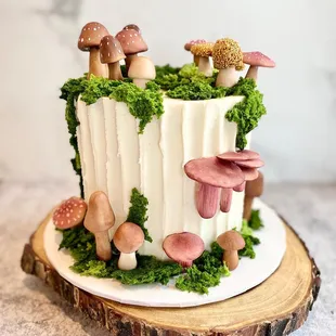 a cake decorated with mushrooms and moss