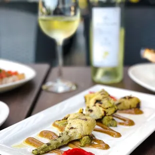 a plate of food and a glass of wine