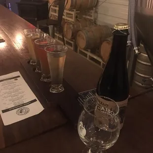 Flight of cider/mead, a bottle of the black currant mead and a glass of pyro cider.