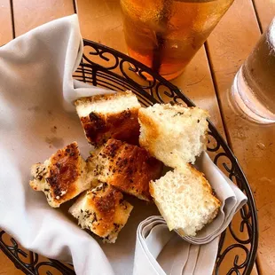 a basket of bread and a drink