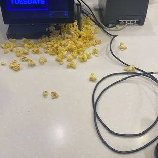 mess of popcorn directly in front of customers
