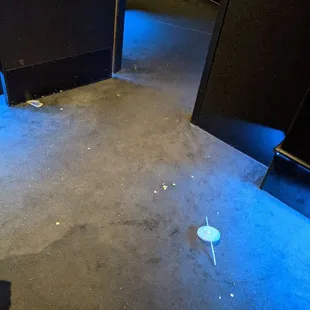 Popcorn and trash on the floor inside the auditorium.