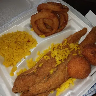 3 piece Whiting dinner with bland yellow rice and average warm onion rings .