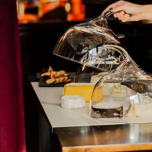a person pouring cheese into a clochet