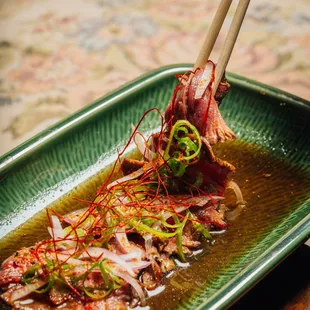 a plate of food with chopsticks