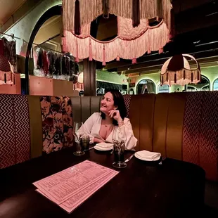 a woman sitting at a table in a restaurant