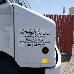 a truck parked in front of a fence