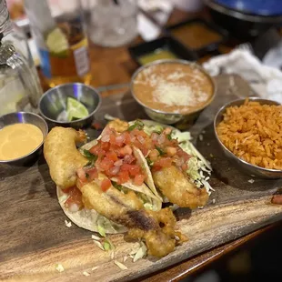 Fried fish tacos, rice and refried beans.
