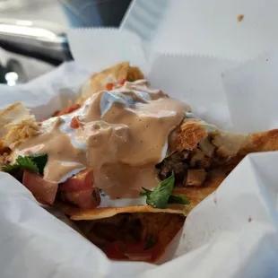 Chicken quesadilla with rice and beans.  Topped with Pico, sour cream, and mild Chipotle