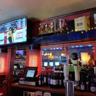 a bar with a large screen tv