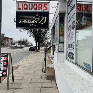 a liquor shop on the corner of a street