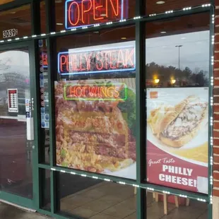 a brick building with a restaurant sign in the window